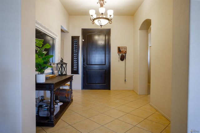 7942 E 36th Ln, Yuma, AZ 85365 - foyer featuring light tile patterned flooring, arched walkways, a chandelier, and baseboards