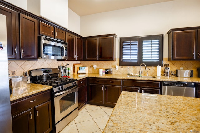 7942 E 36th Ln, Yuma, AZ 85365 - kitchen featuring stainless steel appliances, a sink, light stone countertops, and dark brown cabinets