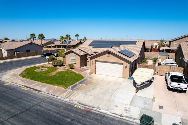 7942 E 36th Ln, Yuma, AZ 85365 - single story home with a garage, stucco siding, roof mounted solar panels, driveway, and a residential view