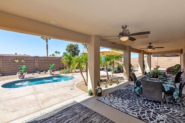 view of patio / terrace with a fenced in pool, a fenced backyard, and a ceiling fan