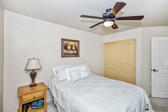 carpeted bedroom with a ceiling fan and a closet