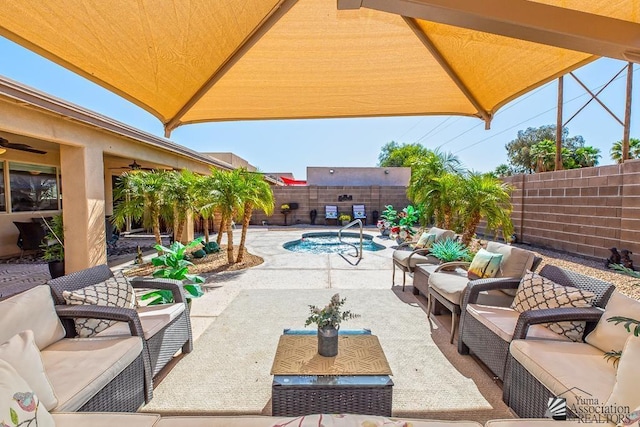 view of patio / terrace with an outdoor living space, a fenced backyard, a ceiling fan, and an in ground hot tub