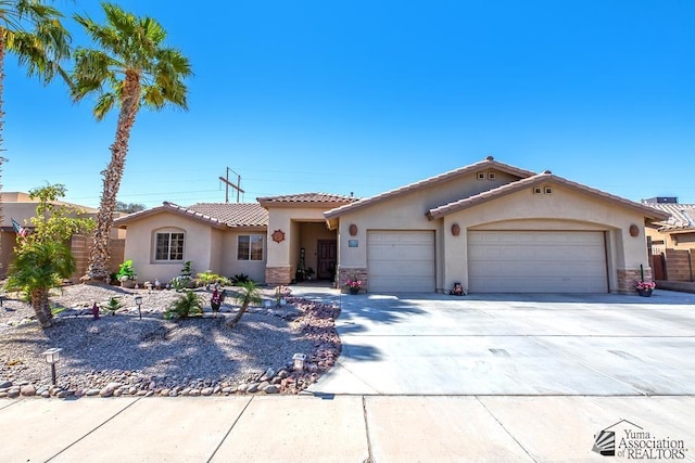 view of front of home featuring a garage, stucco siding, stone siding, and concrete driveway