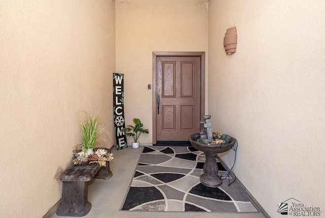 property entrance featuring stucco siding