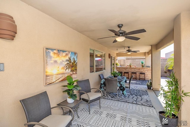view of patio featuring outdoor dry bar and ceiling fan
