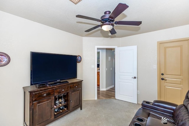 living room with light colored carpet and a ceiling fan