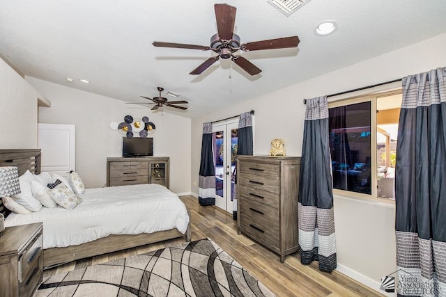 bedroom with visible vents, baseboards, ceiling fan, and wood finished floors