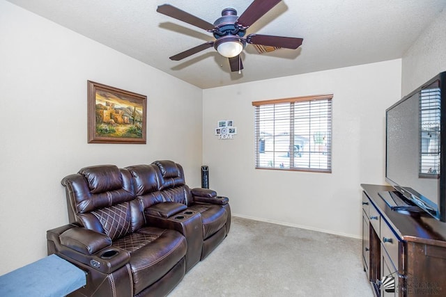 living room featuring baseboards, ceiling fan, and light colored carpet