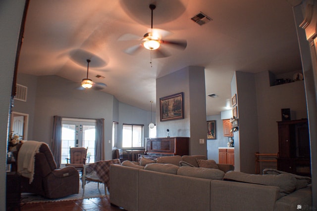 living area with ceiling fan, lofted ceiling, and visible vents