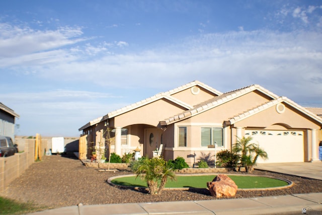 ranch-style home with a garage, fence, stucco siding, and concrete driveway