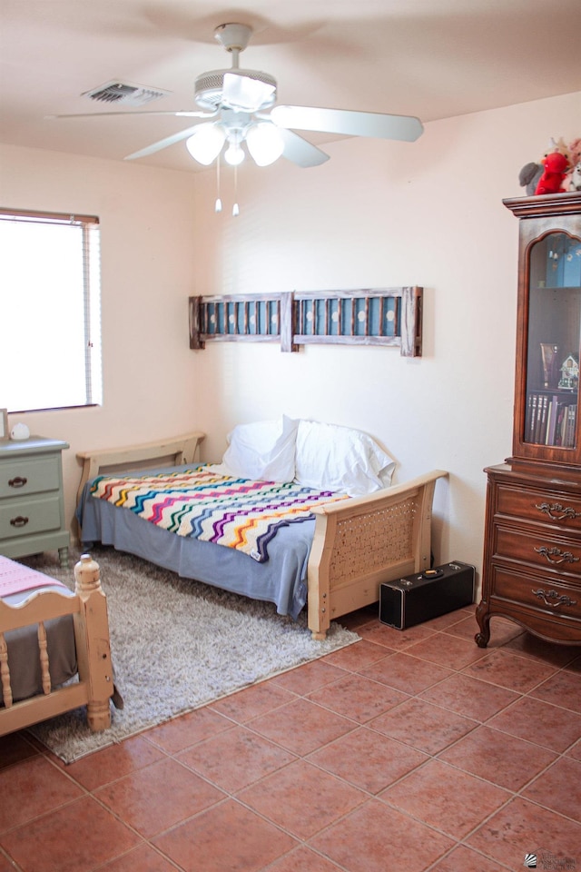 bedroom featuring tile patterned floors and a ceiling fan