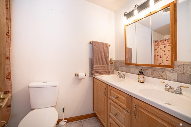 full bathroom with toilet, tile patterned floors, double vanity, and baseboards