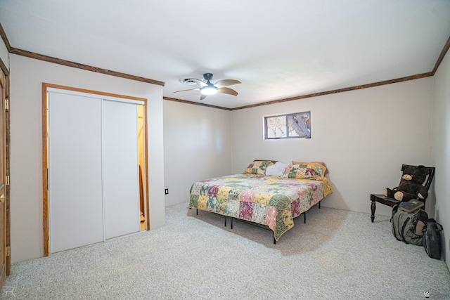 carpeted bedroom with crown molding, a closet, and ceiling fan