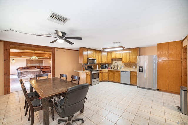dining space featuring light tile patterned floors and ceiling fan