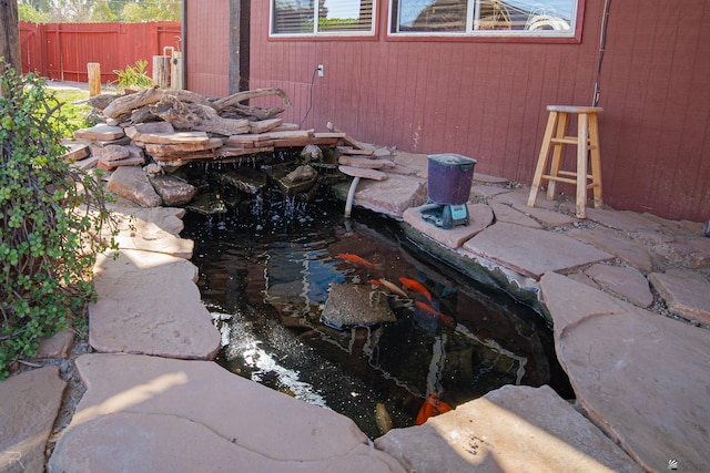 exterior view of a garden pond and fence