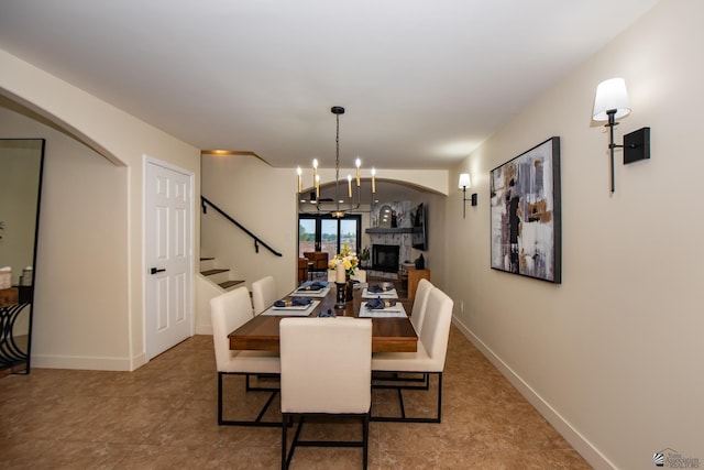 2172 S Terrace Way, Yuma, AZ 85364 - dining area with stairway, a fireplace, arched walkways, and baseboards