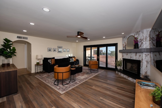 2172 S Terrace Way, Yuma, AZ 85364 - living area with arched walkways, a fireplace, recessed lighting, wood finished floors, and a ceiling fan