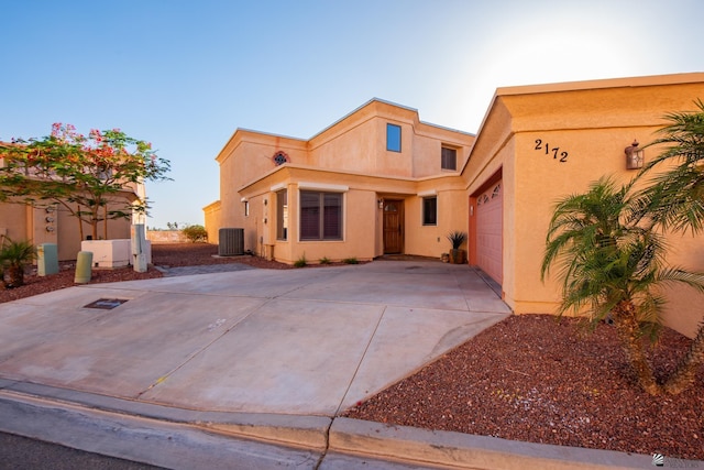2172 S Terrace Way, Yuma, AZ 85364 - view of front of property with cooling unit, concrete driveway, stucco siding, and an attached garage