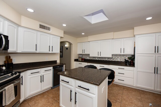 2172 S Terrace Way, Yuma, AZ 85364 - kitchen featuring arched walkways, white cabinets, electric range, tasteful backsplash, and recessed lighting