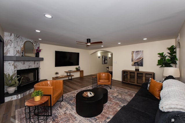 2172 S Terrace Way, Yuma, AZ 85364 - living room featuring arched walkways, wood finished floors, a stone fireplace, a ceiling fan, and recessed lighting
