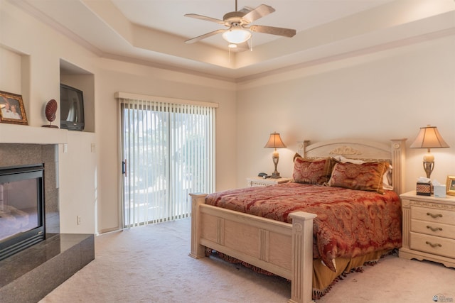 4599 La Quinta Ln, Yuma, AZ 85364 - bedroom with carpet floors, a fireplace, access to exterior, ceiling fan, and a tray ceiling