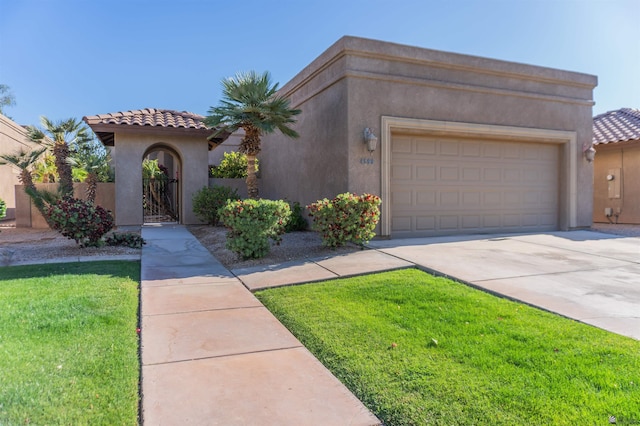 4599 La Quinta Ln, Yuma, AZ 85364 - mediterranean / spanish-style home with a garage, a front yard, stucco siding, a tiled roof, and concrete driveway