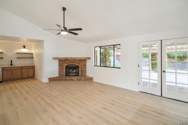 3449 E Seca Ln, Yuma, AZ 85365 - unfurnished living room with vaulted ceiling, light wood-type flooring, a sink, and plenty of natural light
