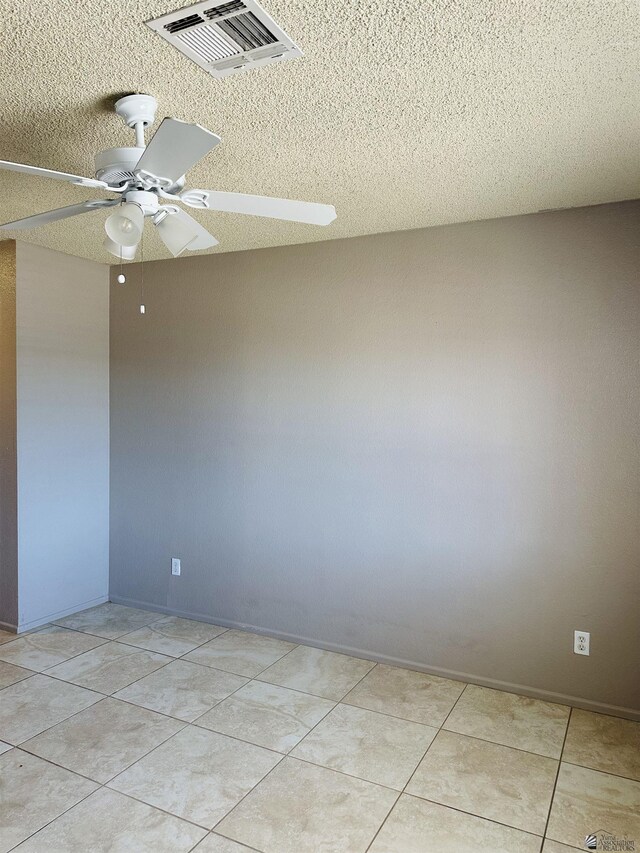 4732 W 17th Ln, Yuma, AZ 85364 - unfurnished room featuring a textured ceiling, a ceiling fan, and light tile patterned floors