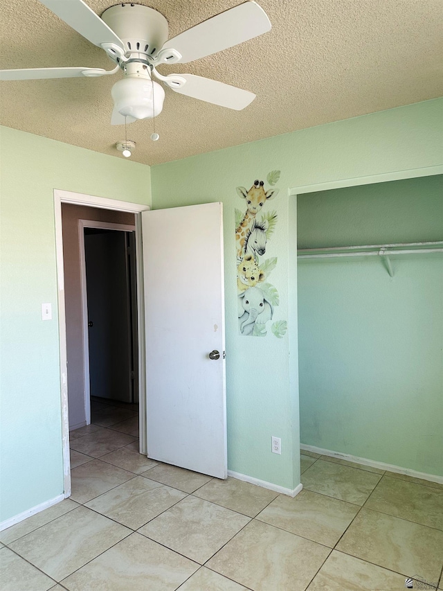 4732 W 17th Ln, Yuma, AZ 85364 - unfurnished bedroom with a textured ceiling, a closet, light tile patterned flooring, and a ceiling fan