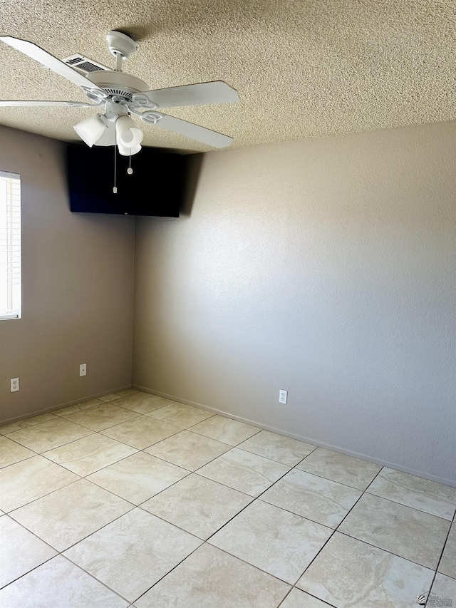 4732 W 17th Ln, Yuma, AZ 85364 - unfurnished room featuring a textured ceiling, ceiling fan, and light tile patterned floors