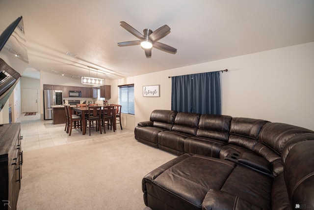 7850 E 44th Pl, Yuma, AZ 85365 - living room featuring a ceiling fan, light carpet, light tile patterned flooring, and lofted ceiling
