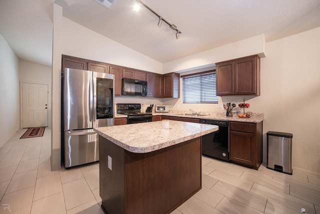 7850 E 44th Pl, Yuma, AZ 85365 - kitchen featuring lofted ceiling, a kitchen island, light countertops, rail lighting, and black appliances