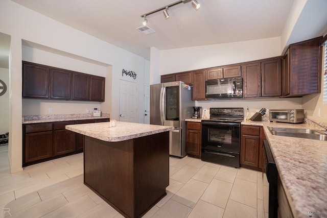 7850 E 44th Pl, Yuma, AZ 85365 - kitchen with light countertops, rail lighting, a sink, black appliances, and vaulted ceiling