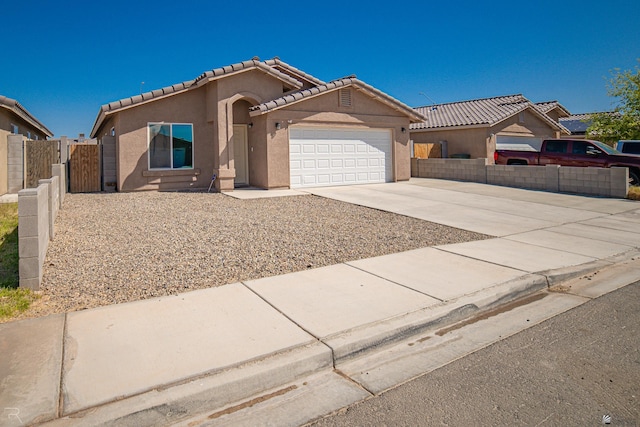 7850 E 44th Pl, Yuma, AZ 85365 - mediterranean / spanish house featuring fence, stucco siding, concrete driveway, an attached garage, and a tile roof