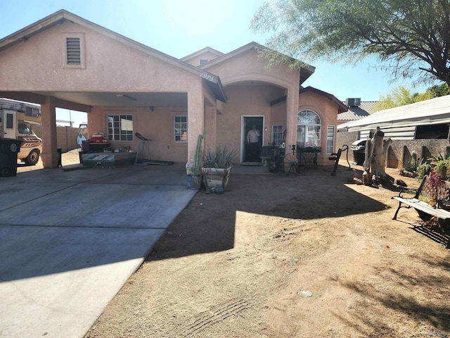 back of house with fence and stucco siding