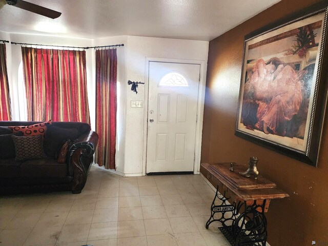 entrance foyer featuring ceiling fan and baseboards