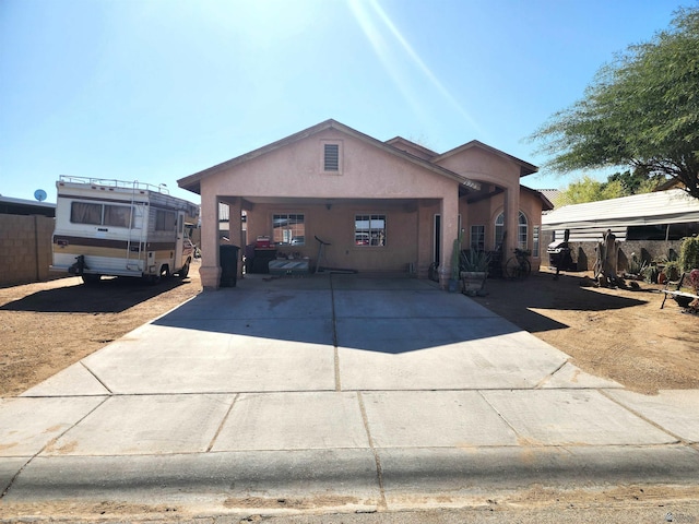 view of front facade featuring concrete driveway and stucco siding