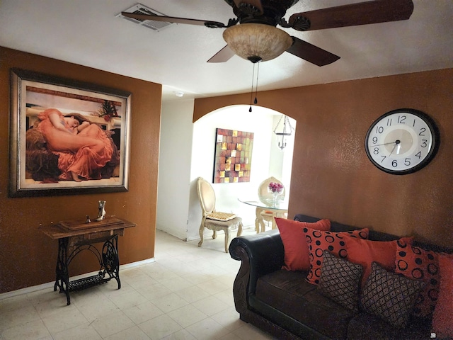 living room featuring a ceiling fan, visible vents, and baseboards