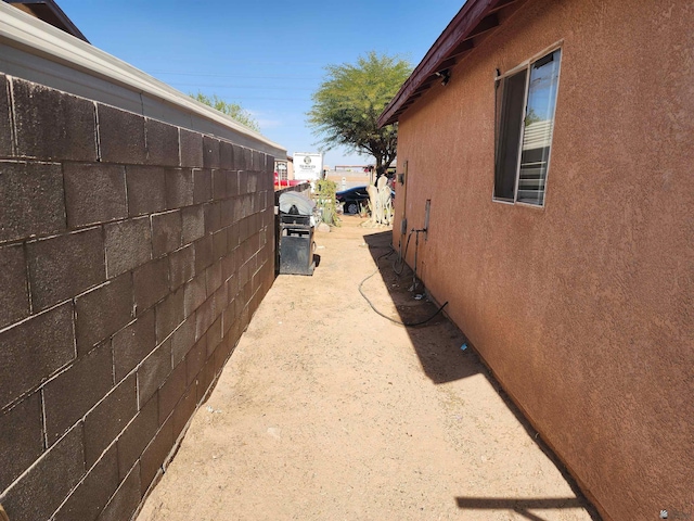 view of home's exterior featuring fence and stucco siding