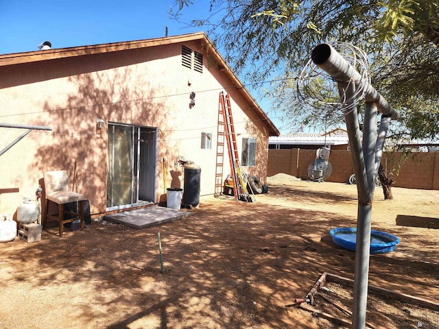 back of house with fence