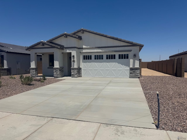 7714 E 35th Pl, Yuma, AZ 85365 - craftsman inspired home featuring stone siding, a garage, a tiled roof, concrete driveway, and board and batten siding