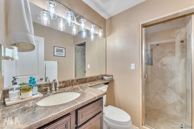 bathroom featuring vanity, toilet, and a stall shower