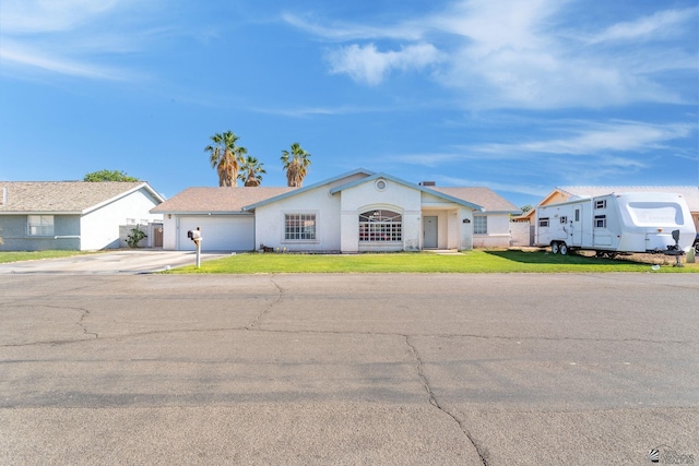 3548 E Moreno Ln, Yuma, AZ 85365 - view of front of property with driveway, an attached garage, a front lawn, and stucco siding