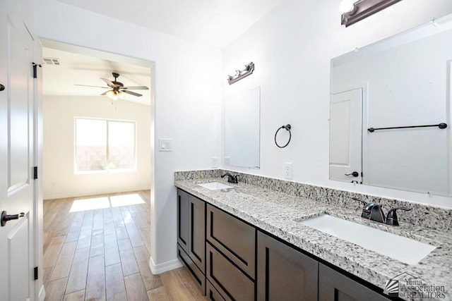 12690 E 51st Pl, Yuma, AZ 85367 - bathroom featuring a ceiling fan, wood finished floors, baseboards, and double vanity