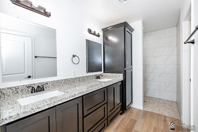 12690 E 51st Pl, Yuma, AZ 85367 - bathroom with a walk in shower, double vanity, and wood finished floors