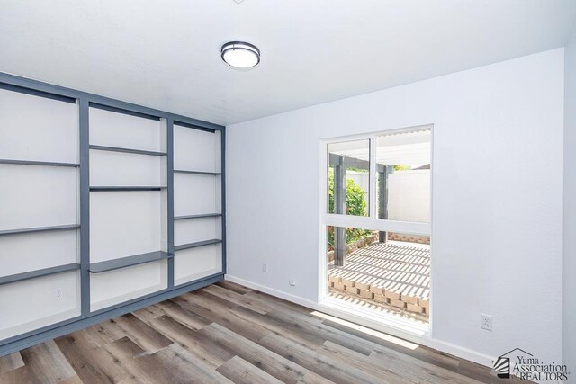 1934 S Athens Ave, Yuma, AZ 85364 - empty room with baseboards and wood finished floors