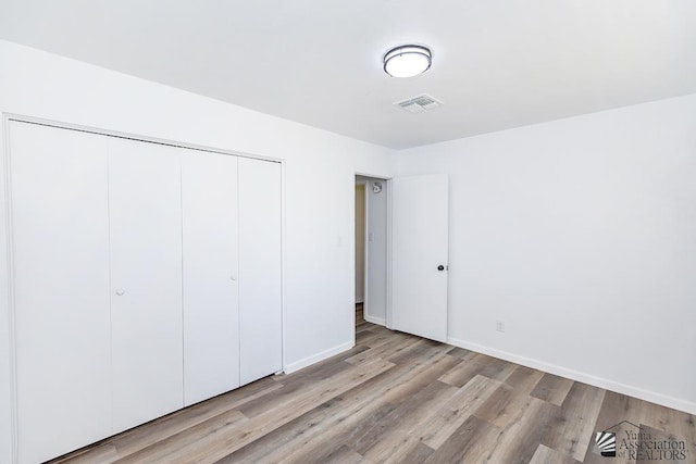 1934 S Athens Ave, Yuma, AZ 85364 - unfurnished bedroom with wood finished floors, a closet, and baseboards