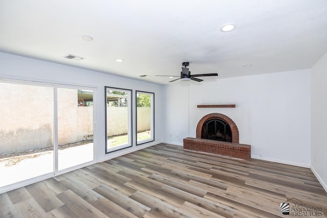 1934 S Athens Ave, Yuma, AZ 85364 - unfurnished living room with a ceiling fan, a brick fireplace, recessed lighting, baseboards, and wood finished floors