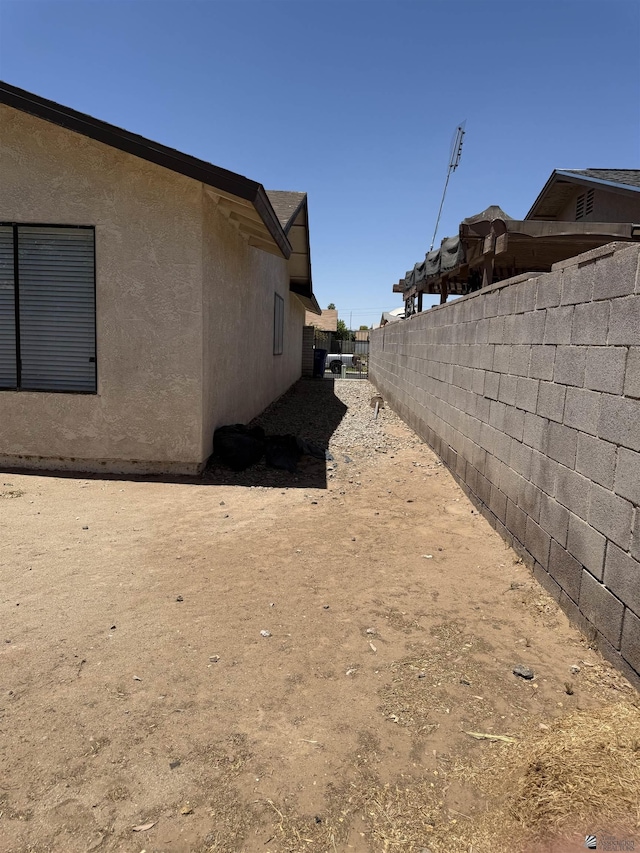1435 S Thomas Ave, Yuma, AZ 85364 - view of home's exterior featuring fence and stucco siding