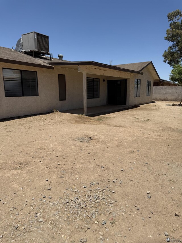 1435 S Thomas Ave, Yuma, AZ 85364 - back of property with cooling unit, stucco siding, and a patio
